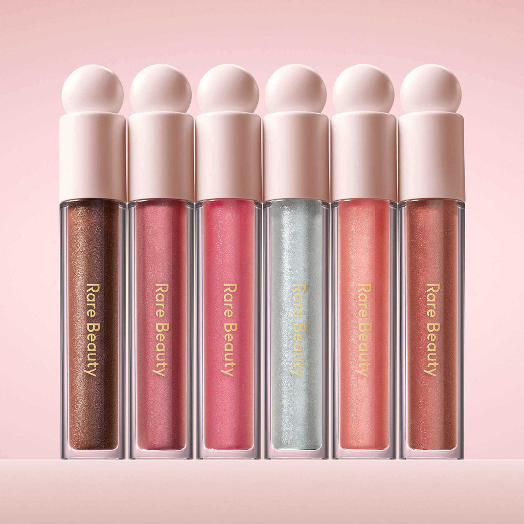 Rare Beauty Positive Light Lip Gloss with shimmering pearlescent finish in gold tones